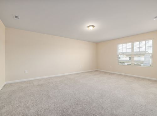 This is a photo of an empty room with cream carpets works carried out by Mile End Carpet Cleaning