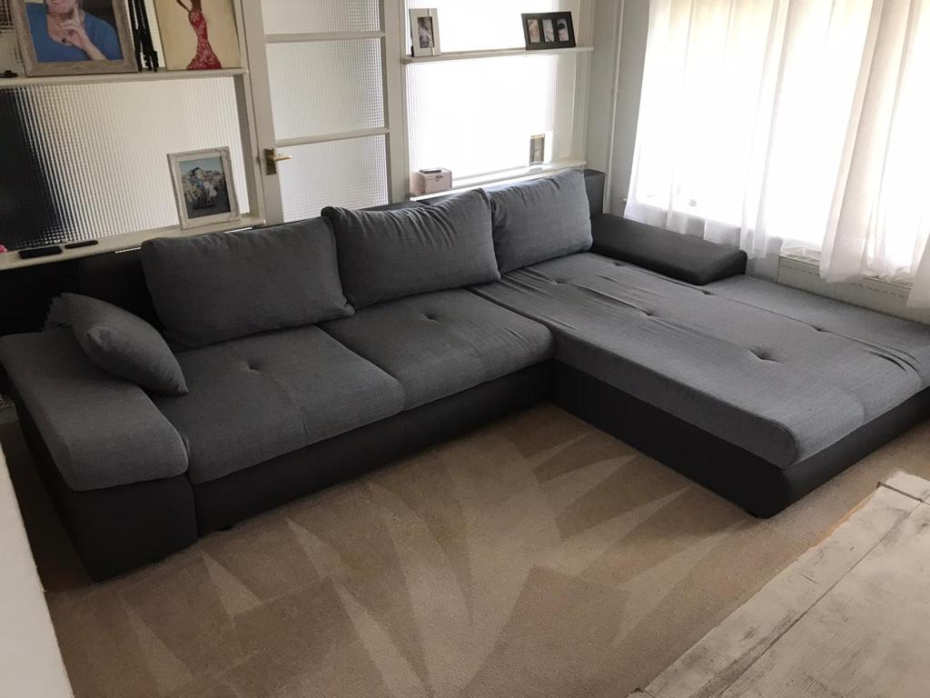 This is a photo of a grey L shape sofa that has been professionally steam cleaned, also the beige carpets have been steam cleaned too works carried out by Mile End Carpet Cleaning