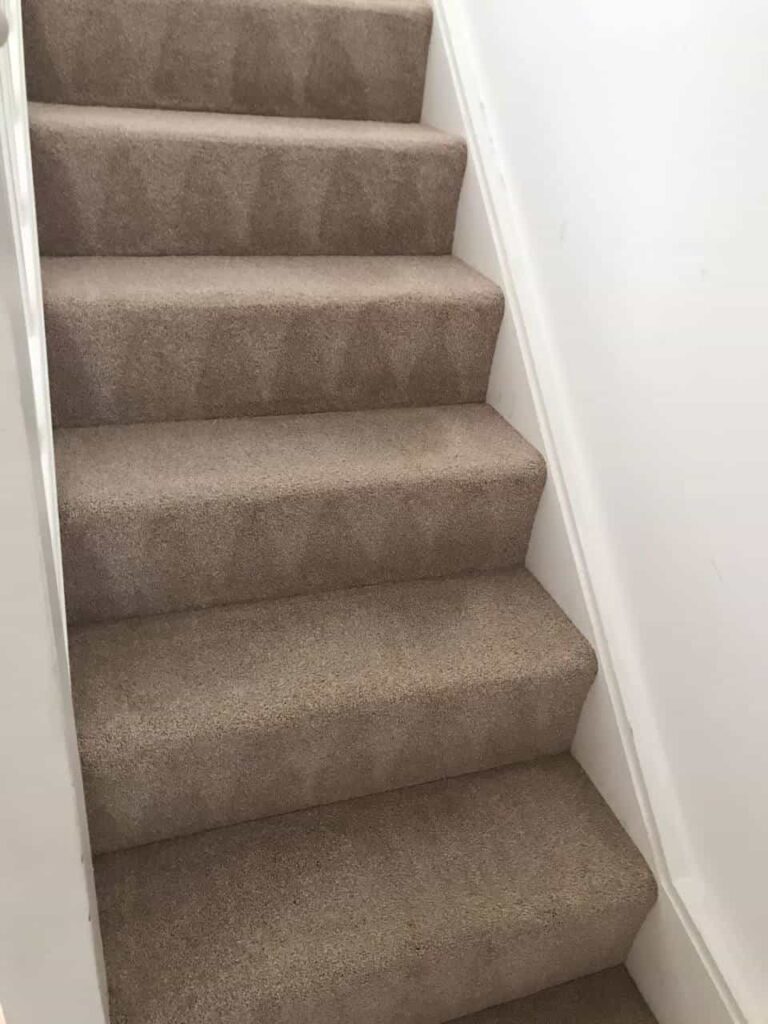 This is an after photo of a staircase with a beige carpet that has been cleaned works carried out by Mile End Carpet Cleaning